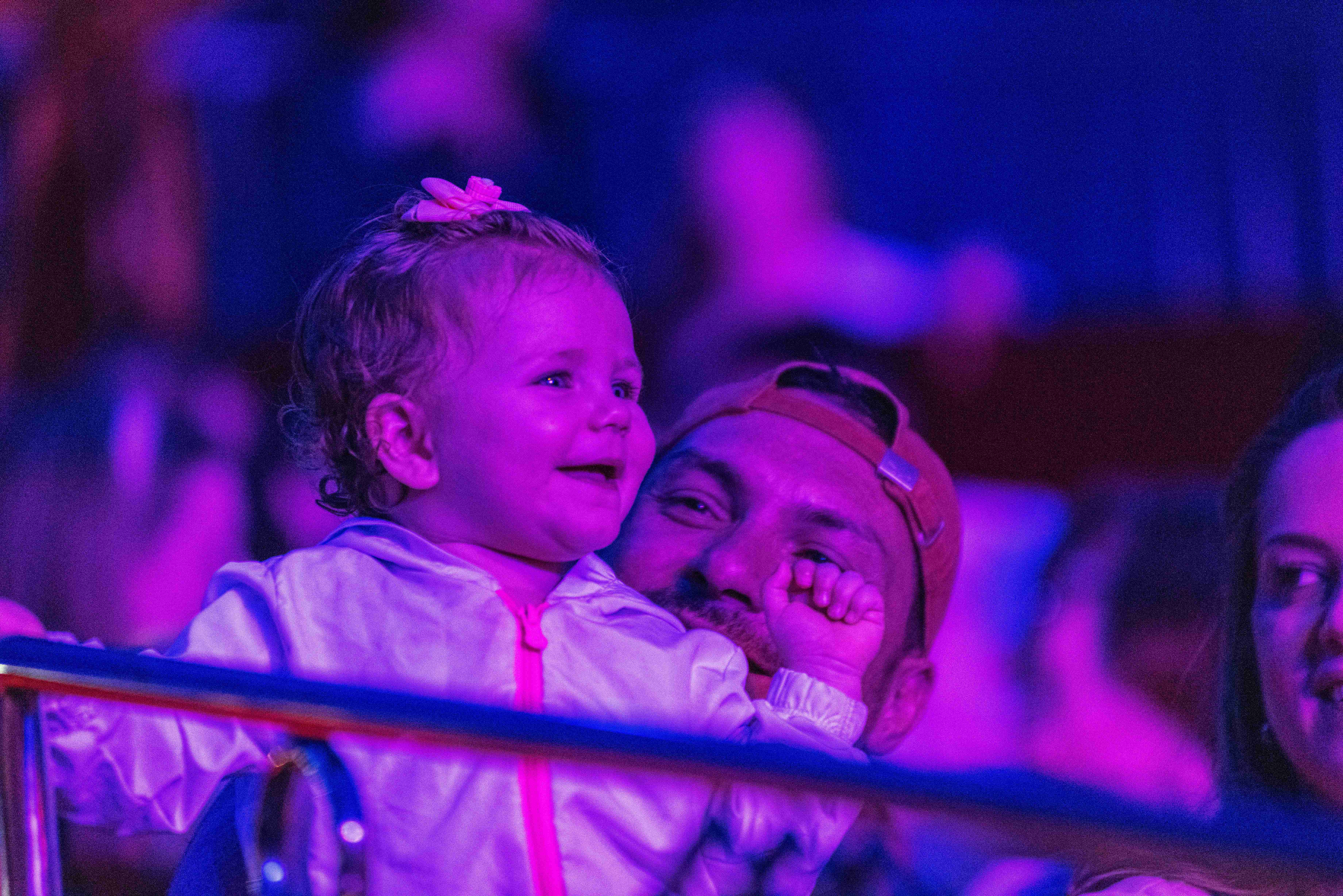 Pai e filha assistindo ao espetáculo iluminados